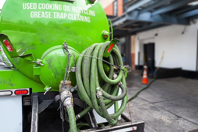 a professional service truck pumping a grease trap in East Berne, NY